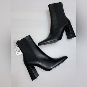 Black leather boots, brand new with tags.